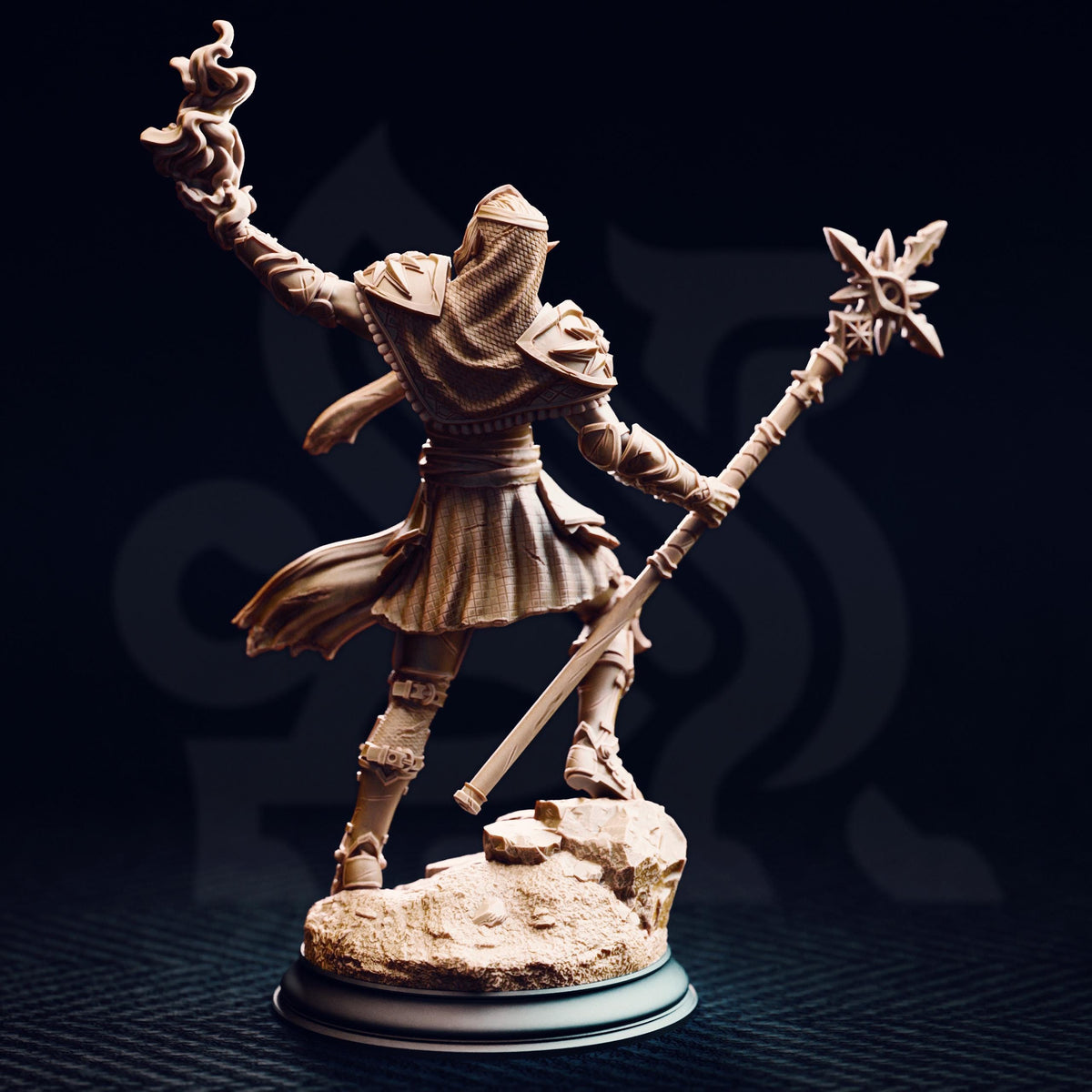 A figurine of a person holding a staff and a staff-like object, standing on a rock.