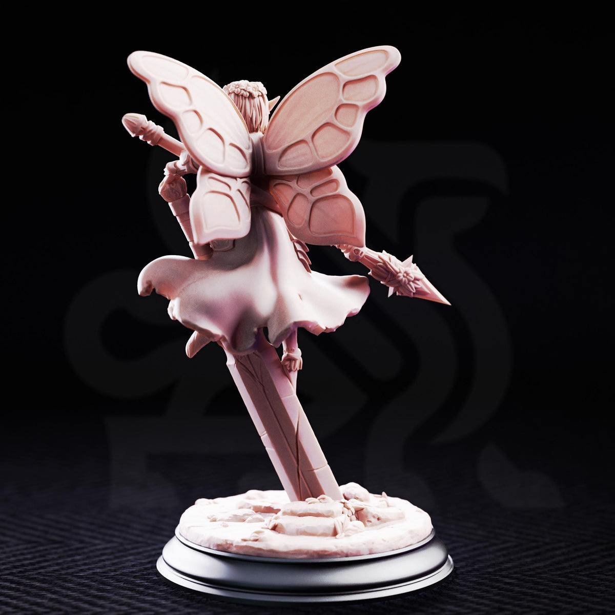 A figurine of a fairy or magical creature with wings and a flowing dress, standing on a pedestal and holding a wand.