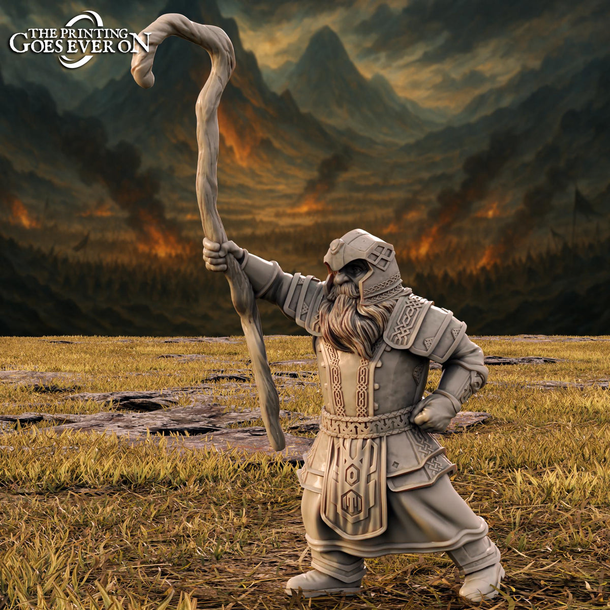 A statue of a bearded man holding a staff stands in a field with a mountainous landscape in the background.