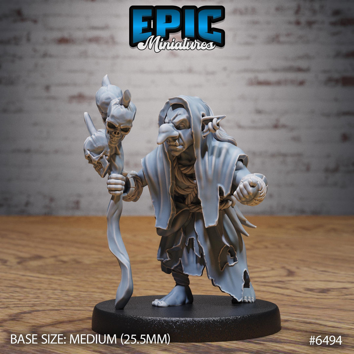 A figurine of a character with a staff and a skull on it, sitting on a black base.