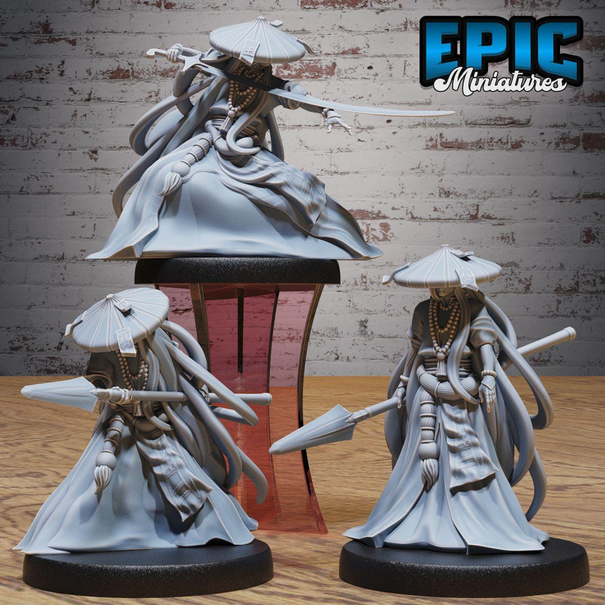 three figurines of characters with long hair and traditional clothing, each holding a weapon and standing on a platform.