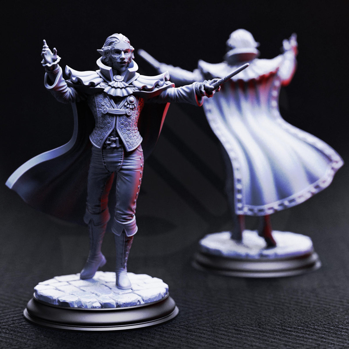 two figurines of a man in a cape, standing on pedestals and holding weapons.