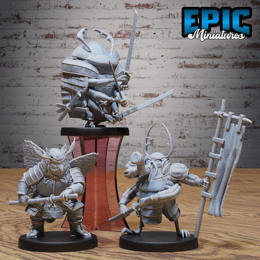 three figurines of characters from the video game Epic Miniatures, displayed on a wooden surface against a brick wall background.