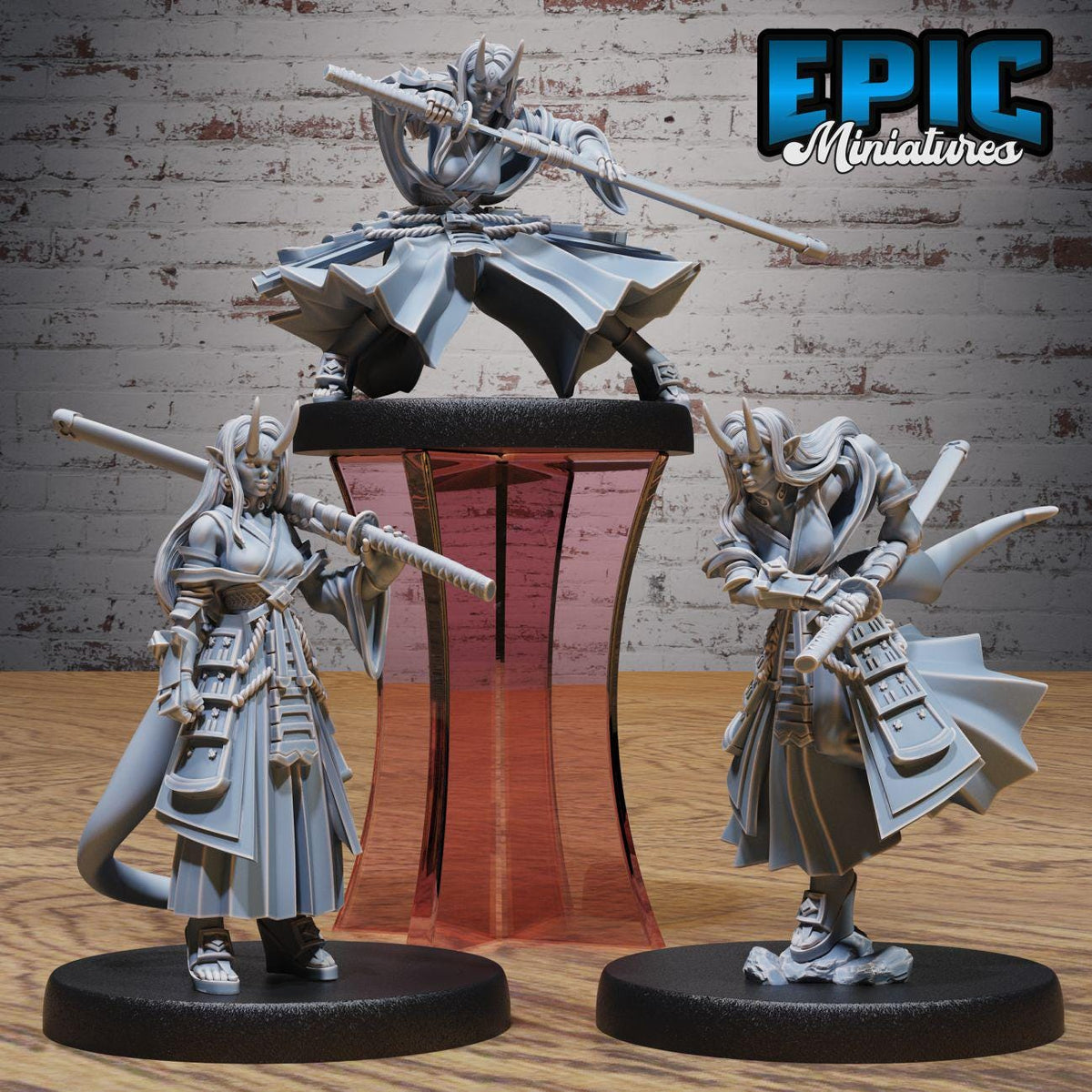 three figurines of characters from a video game, each holding a weapon and standing on a platform.