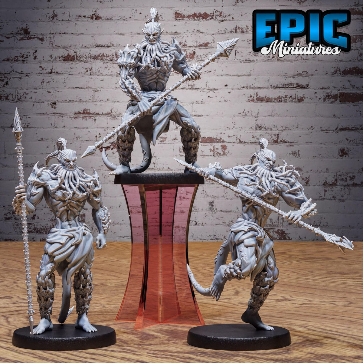 three figurines of fantastical creatures, each holding a weapon and standing on a platform.