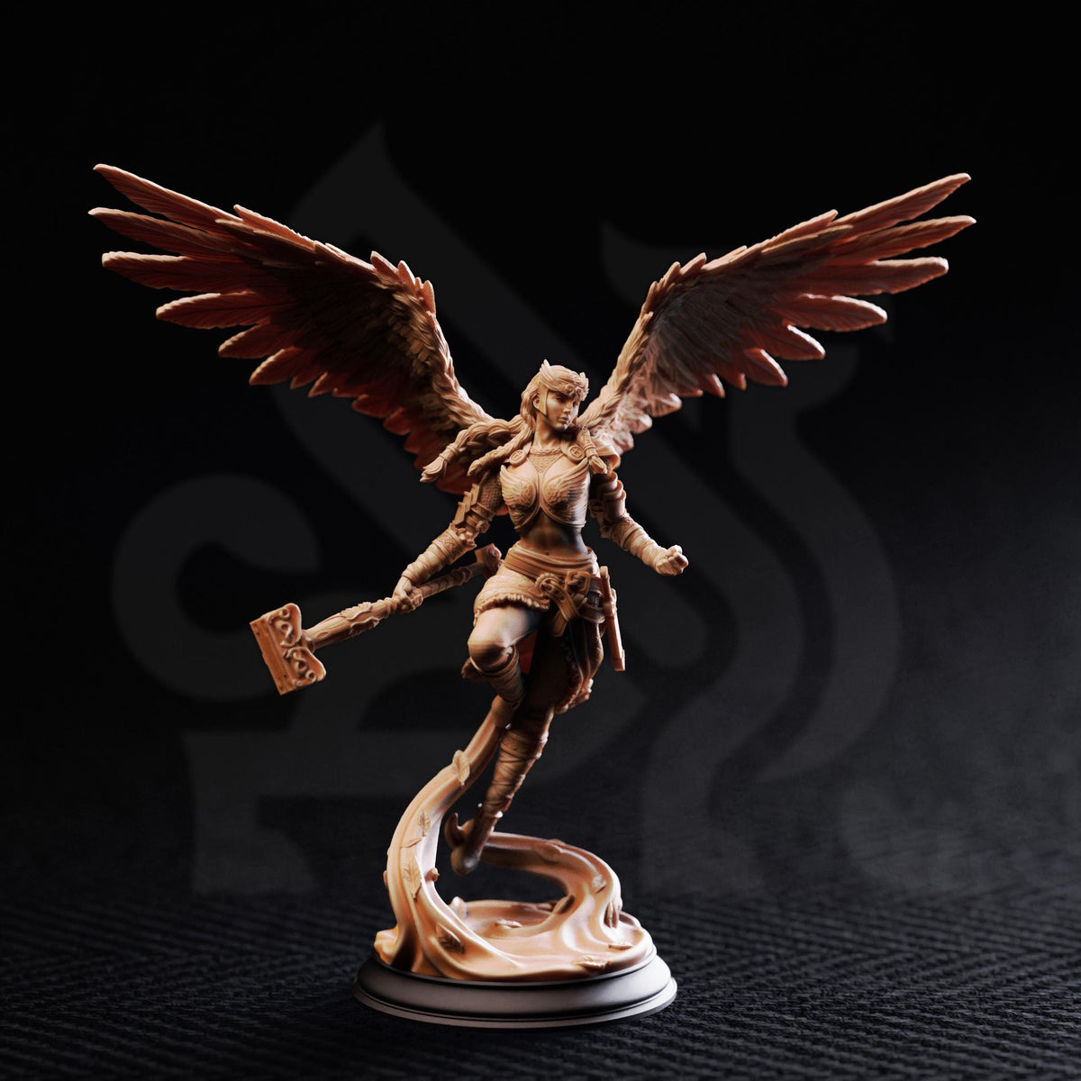 A figurine of a winged female warrior figure holding a weapon, standing on a base against a dark background.