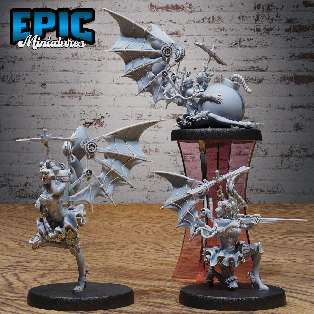 three miniature figurines of fantastical creatures, including winged and armored figures, displayed on a wooden surface against a brick wall background.