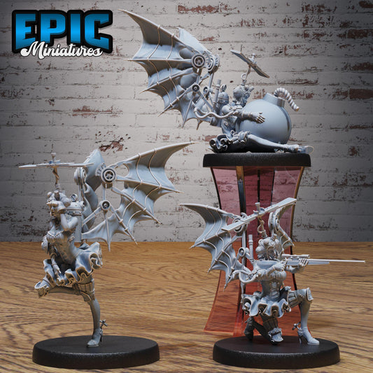 three miniature figurines of fantastical creatures, including winged and armored figures, displayed on a wooden surface against a brick wall background.