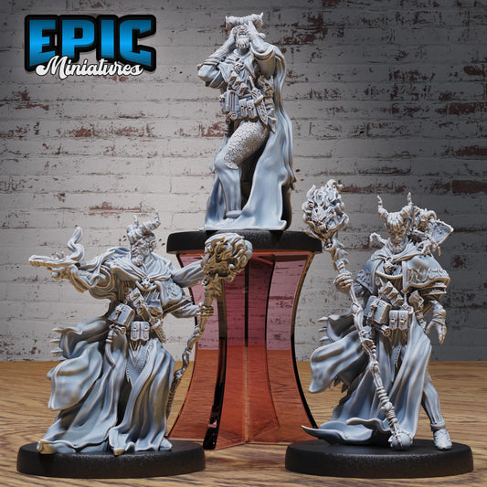three figurines of characters from a fantasy or science fiction setting, displayed on a stand against a brick wall background.