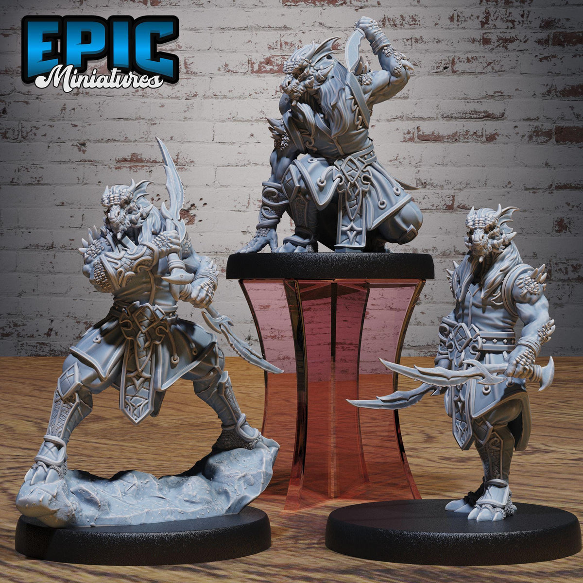 three detailed figurines of fantasy characters, each with unique poses and weapons, displayed on a wooden surface against a brick wall background.