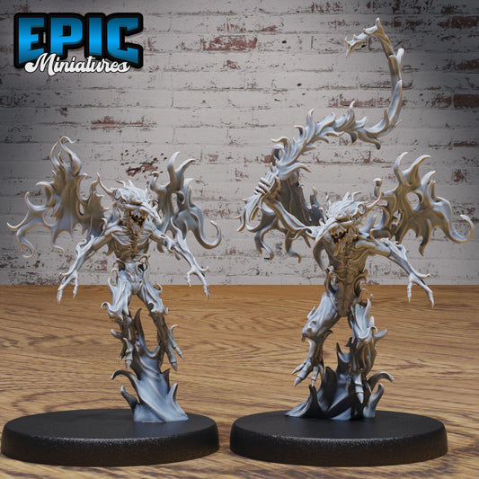 two figurines of fantastical creatures, possibly mythical or magical, standing on a wooden surface against a brick wall background.