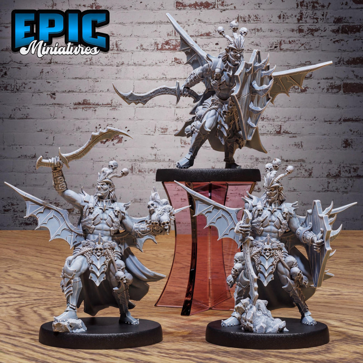 three detailed figurines of winged, armored characters, likely from a fantasy or science fiction game.
