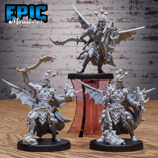 three detailed figurines of winged, armored characters, likely from a fantasy or science fiction game.