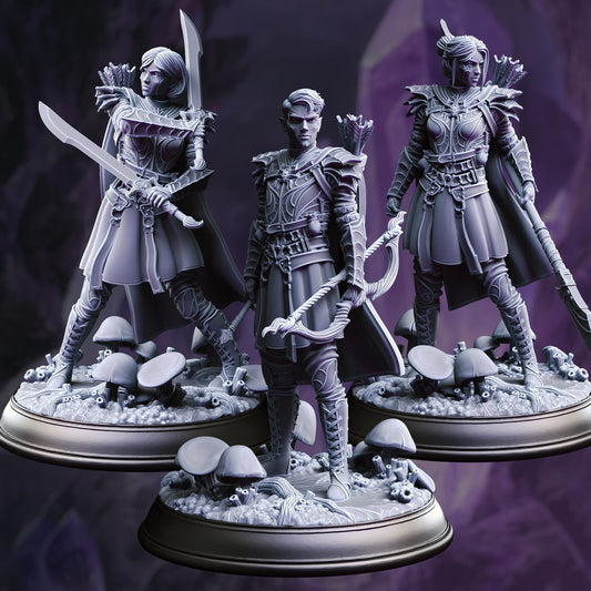 three detailed figurines of characters from a fantasy setting, each holding various weapons and standing on a base with mushrooms.