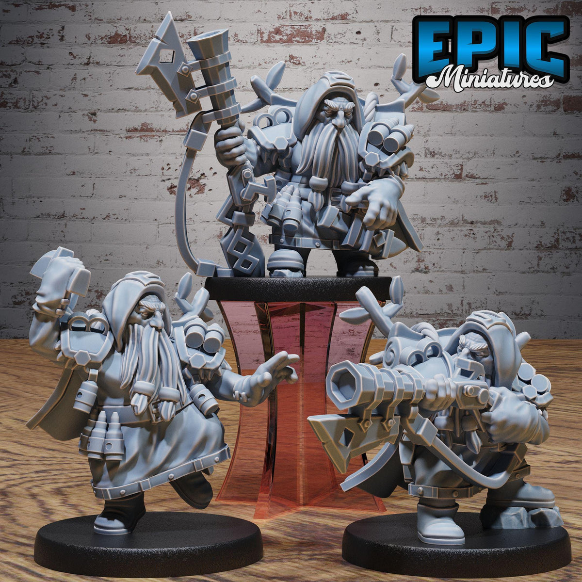 three figurines of dwarfs, each with unique poses and weapons, set against a brick wall background.