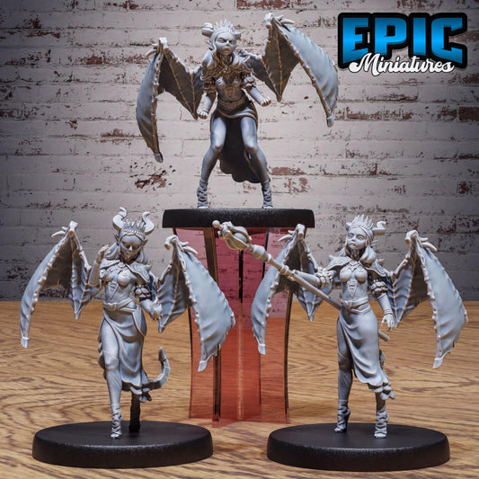 three figurines of winged, winged-haired, winged-winged female characters, each with unique poses and accessories.