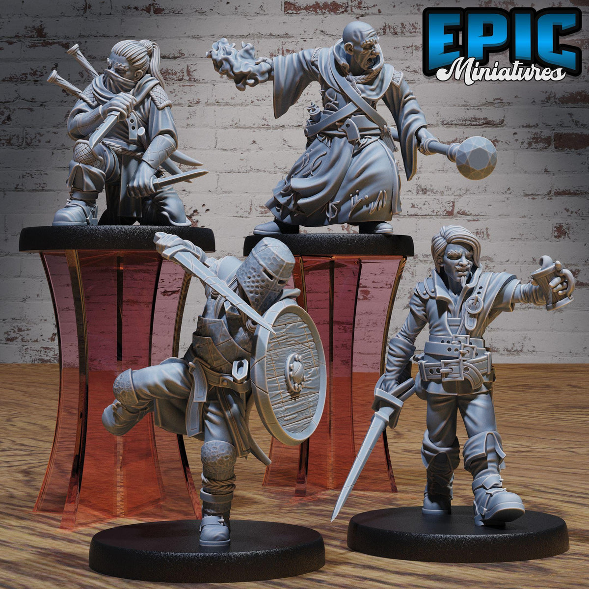 three figurines of medieval-style characters, each holding various weapons and standing on platforms.