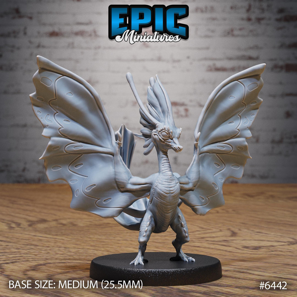 A 3D model of a winged creature, possibly a dragon or mythical creature, with large, detailed wings. The creature is standing on a black base and is positioned in front of a brick wall.