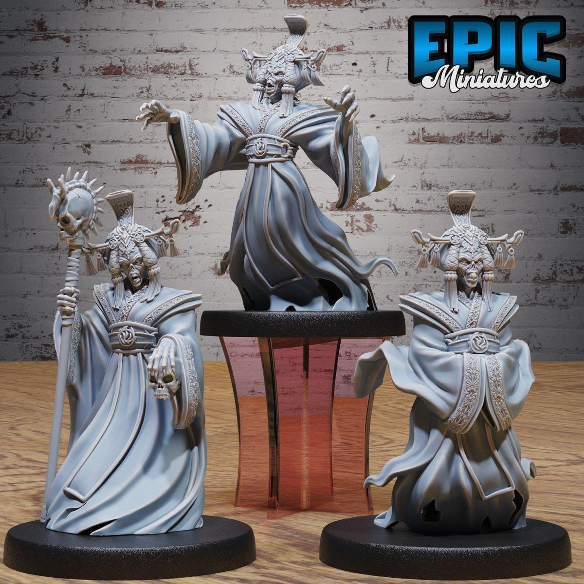 three figurines of fantastical creatures, each with unique features and attire, displayed on a wooden surface against a brick wall background.