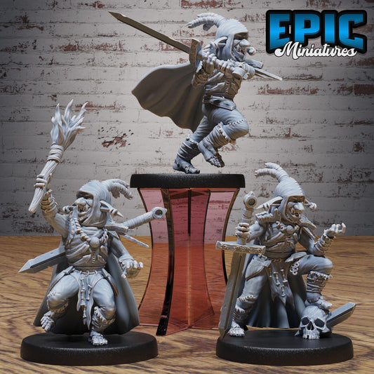 three figurines of fantasy characters, including a knight, a dragon, and a dragon-like creature, posed on a wooden surface against a brick wall background.