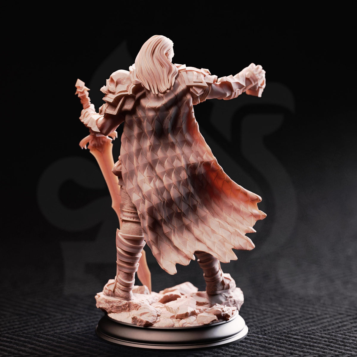 A figurine of a warrior figure, possibly a knight or knightly figure, standing on a rocky base and holding a sword.