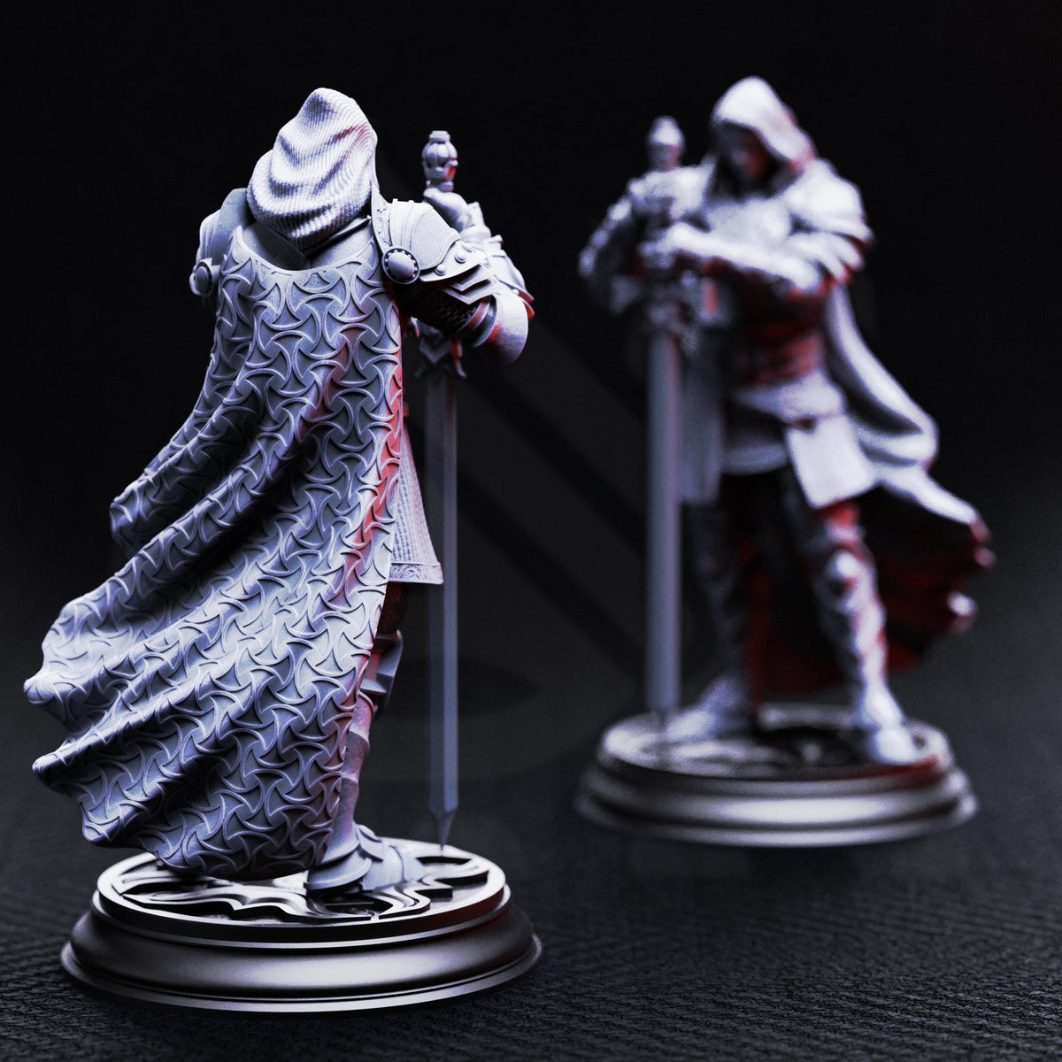 two figurines of a knight, one standing and one kneeling, both wearing armor and holding swords.