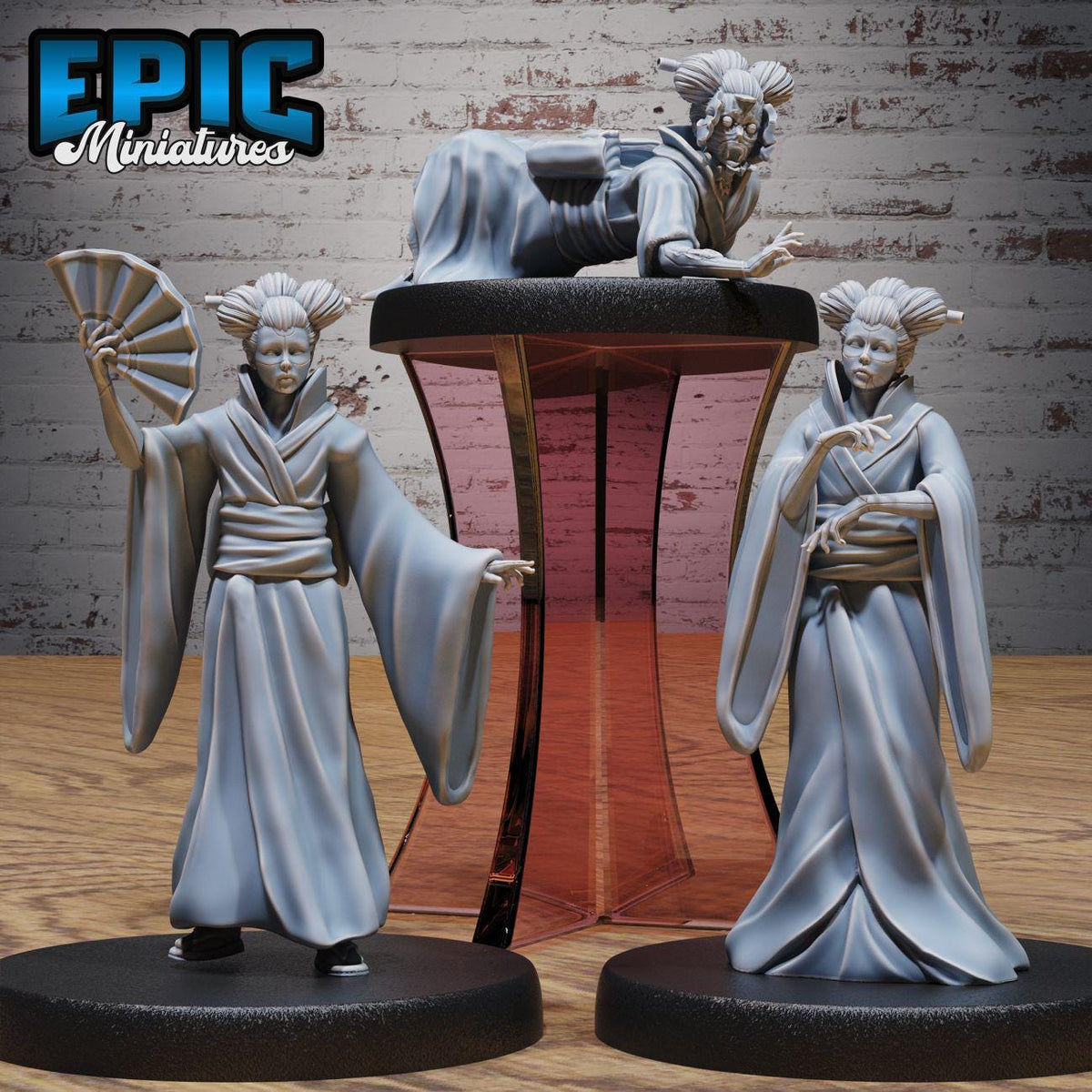 three figurines of women in traditional Japanese attire, including geisha-style clothing, standing on a platform.