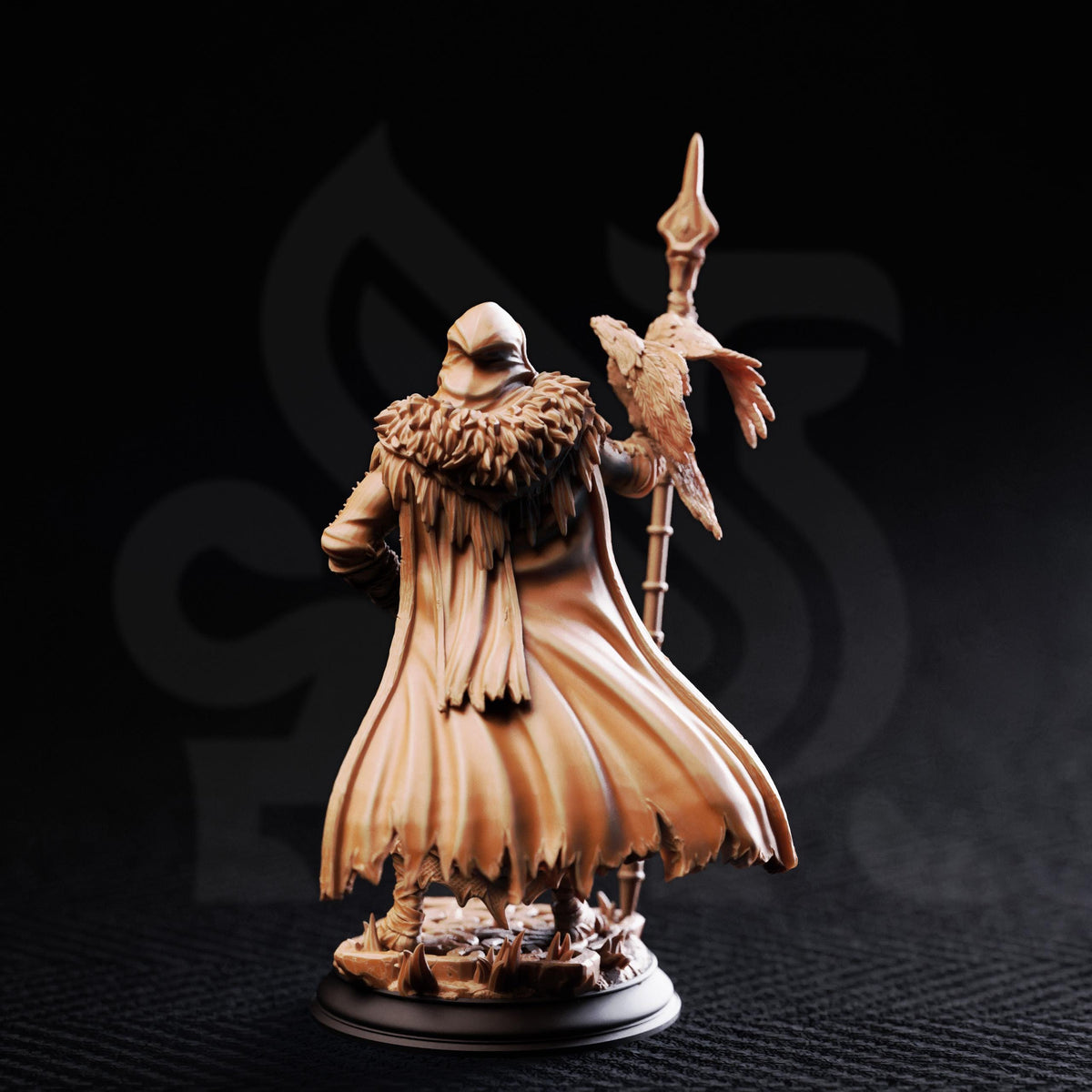 A figurine of a person wearing a long, flowing robe and holding a staff, with a bird perched on it.