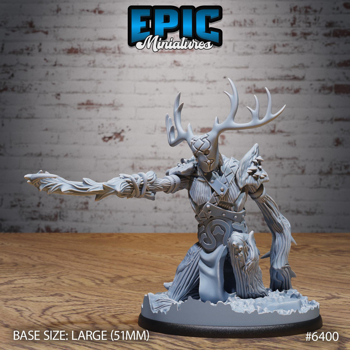 A detailed miniature figurine of a fantastical creature with antlers, a large sword, and a distinctive headdress, set against a brick wall background.