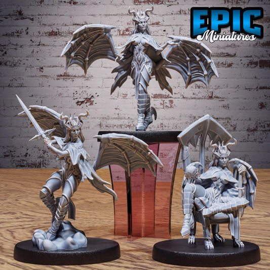 three figurines of winged, winged-winged, winged-winged creatures, possibly representing fantasy creatures or characters, displayed on a wooden surface against a brick wall background.