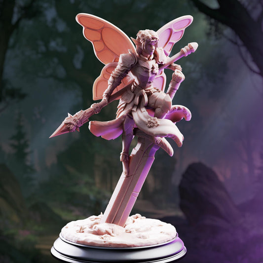 A figurine of a winged, armored figure holding a spear and standing on a pedestal against a forest background.