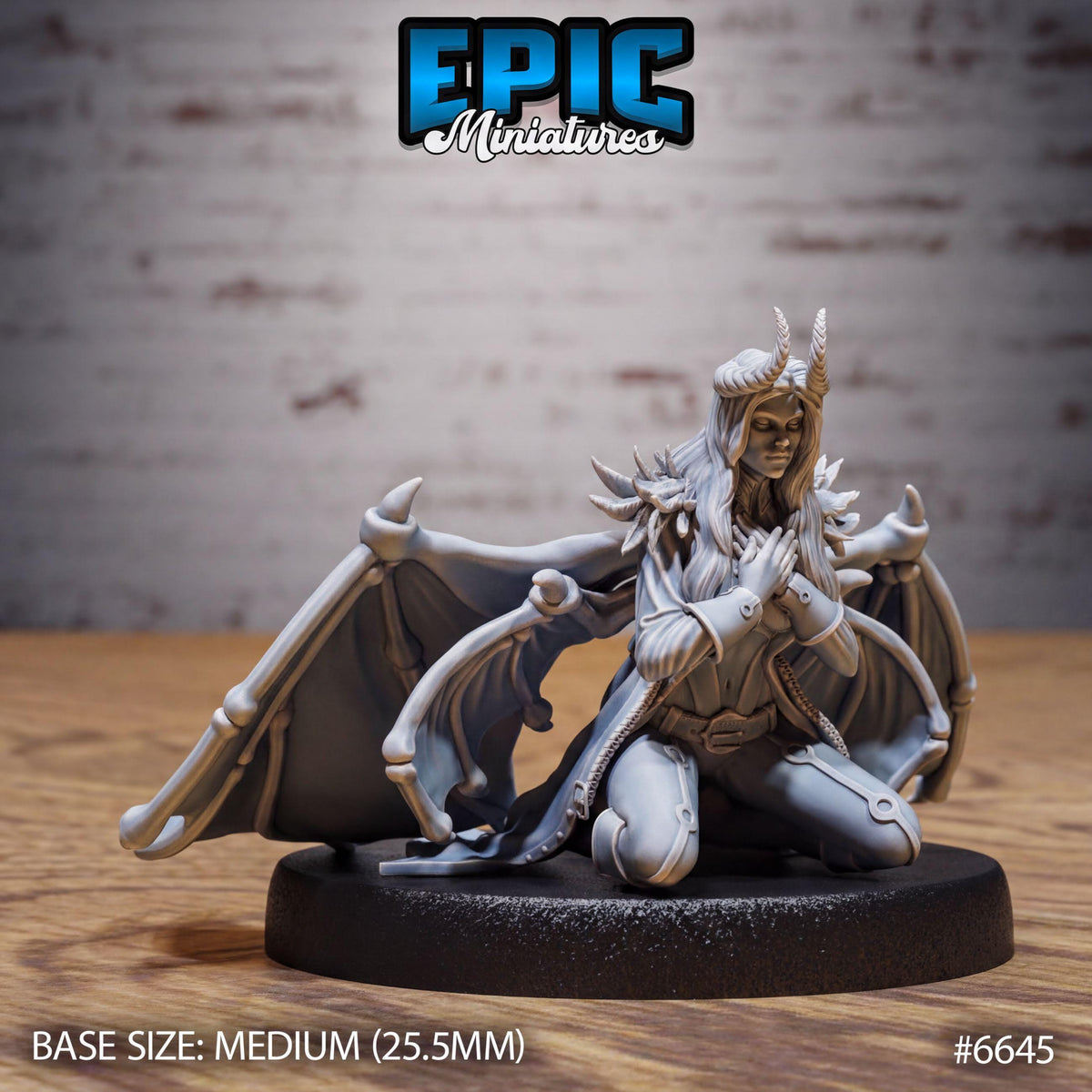 A figurine of a winged, winged creature with horns and a flowing robe, sitting on a black base.