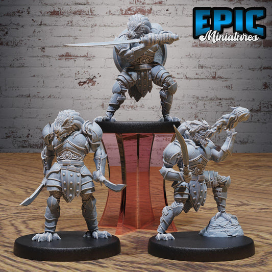 three figurines of dragons, each holding a sword and standing on a platform.
