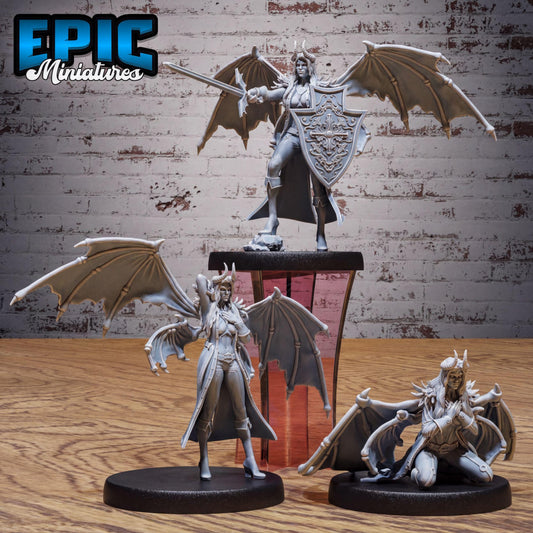 three figurines of winged, armored characters, likely from a fantasy or action-adventure game.