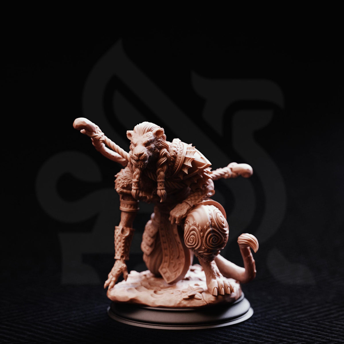 A detailed sculpture of a crouching, armored figure with a fierce expression, set against a dark background.