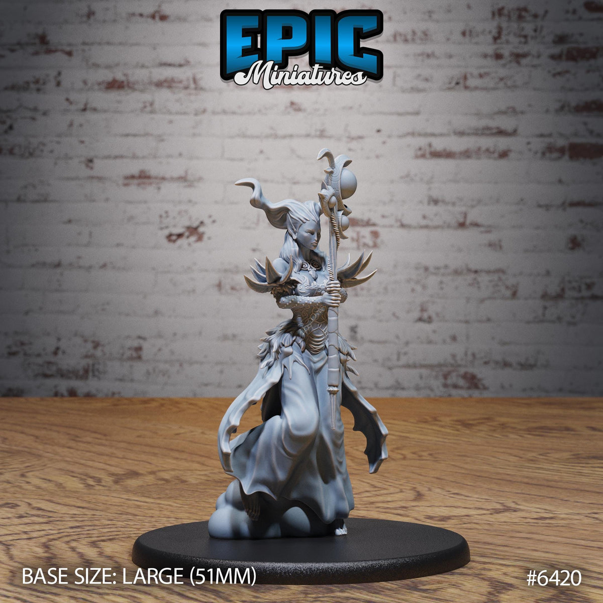 A figurine of a female character with horns and a staff, standing on a black base. The figurine appears to be a miniature model of a fantasy character.