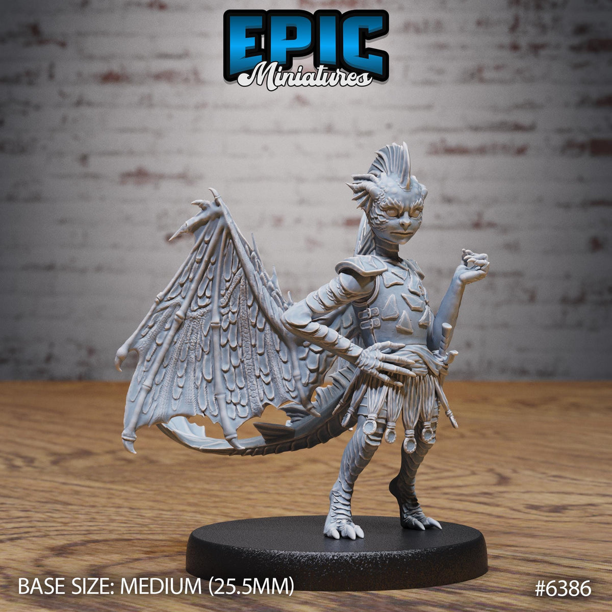 A detailed figurine of a winged creature, possibly a dragon or mythical creature, standing on a black base. The figurine is described as a "MEDIUM" size, with a wingspan of 25.5 millimeters. The background is a brick wall, and the figurine is placed on a wooden surface.
