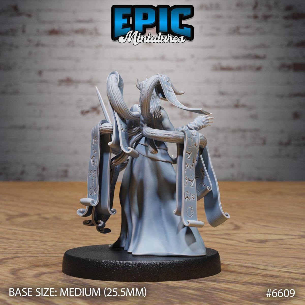 A figurine of a winged, winged creature with a long, flowing robe and a staff, standing on a black base. The figurine appears to be a miniature model of a winged, winged creature, possibly a fantasy or sci-fi character.