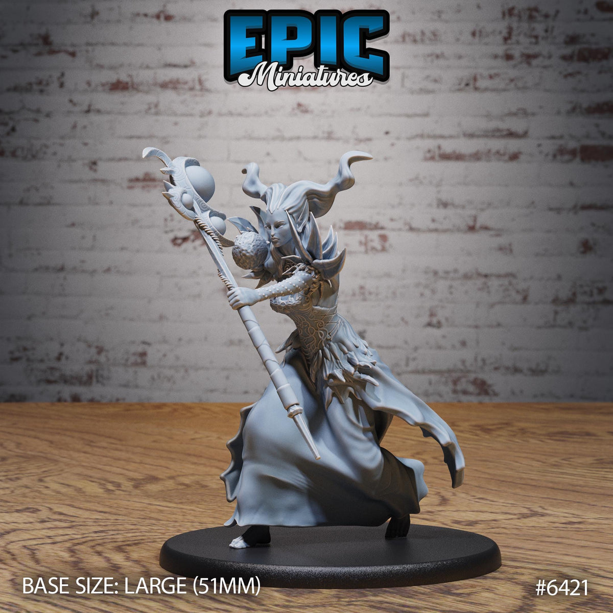 A figurine of a female character with long hair and a flowing dress, holding a staff, is displayed on a black base.