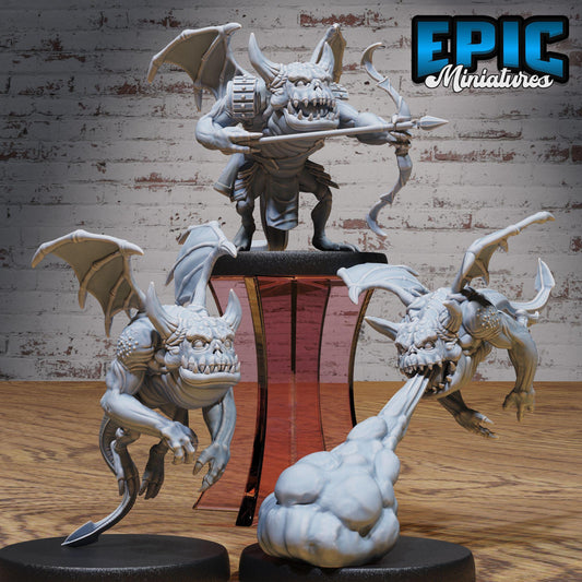 three detailed, miniature figurines of fantastical creatures, including winged, armored, and armored creatures, set against a brick wall background.
