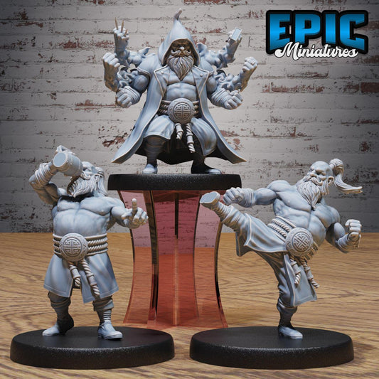 three miniature figures, each with unique poses and expressions, set against a brick wall background.