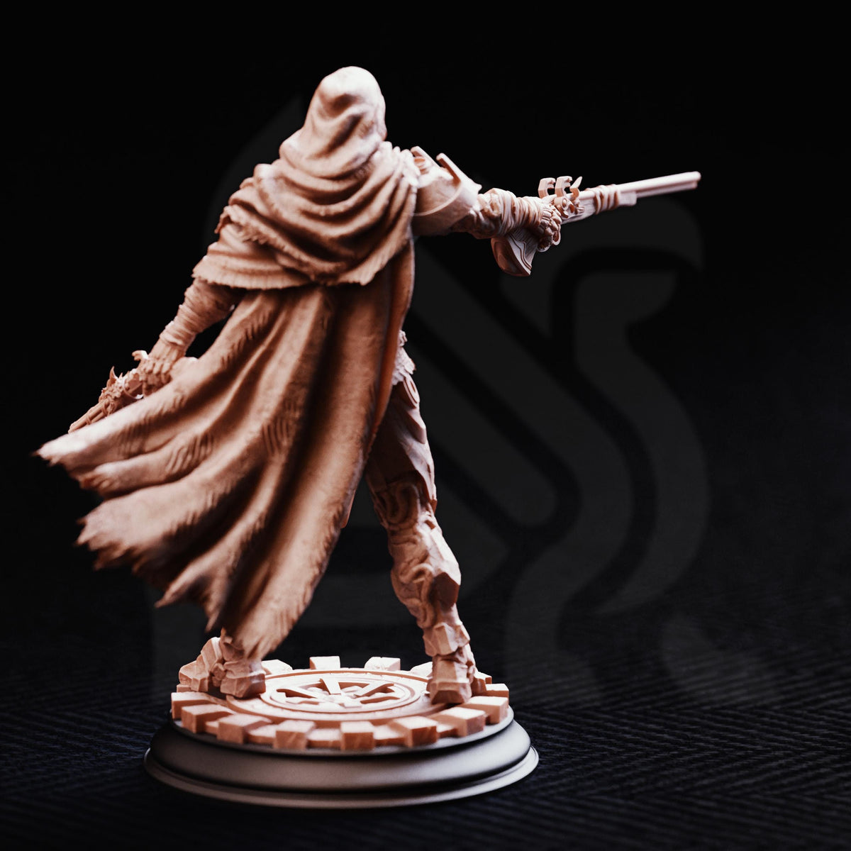 A figurine of a person in a cape and holding a weapon, standing on a platform with a circular emblem.