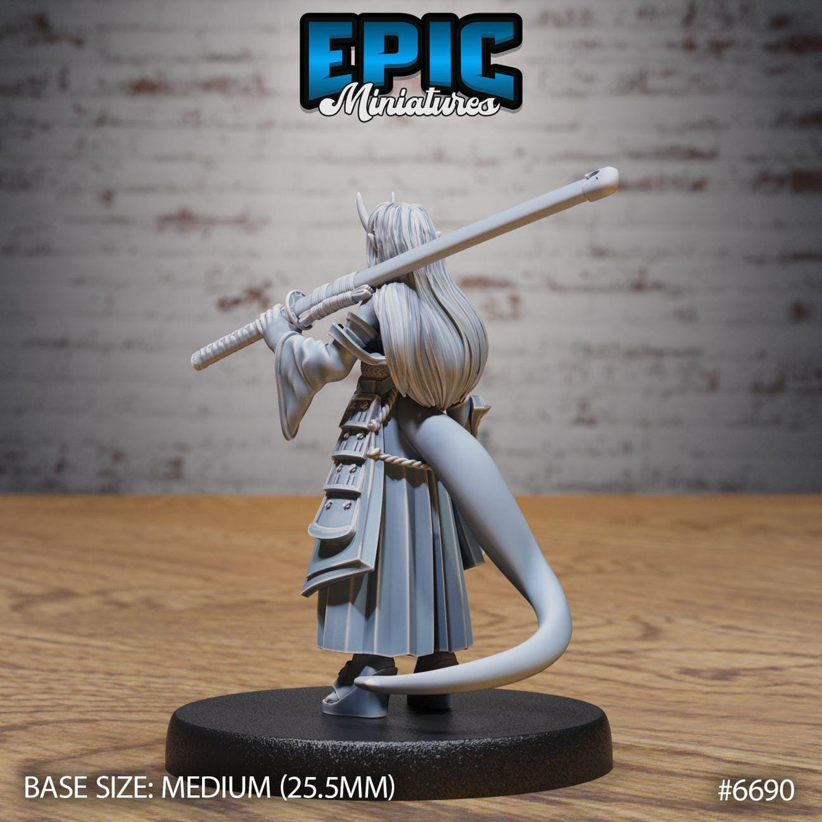 A figurine of a person holding a sword and a staff, standing on a black base.
