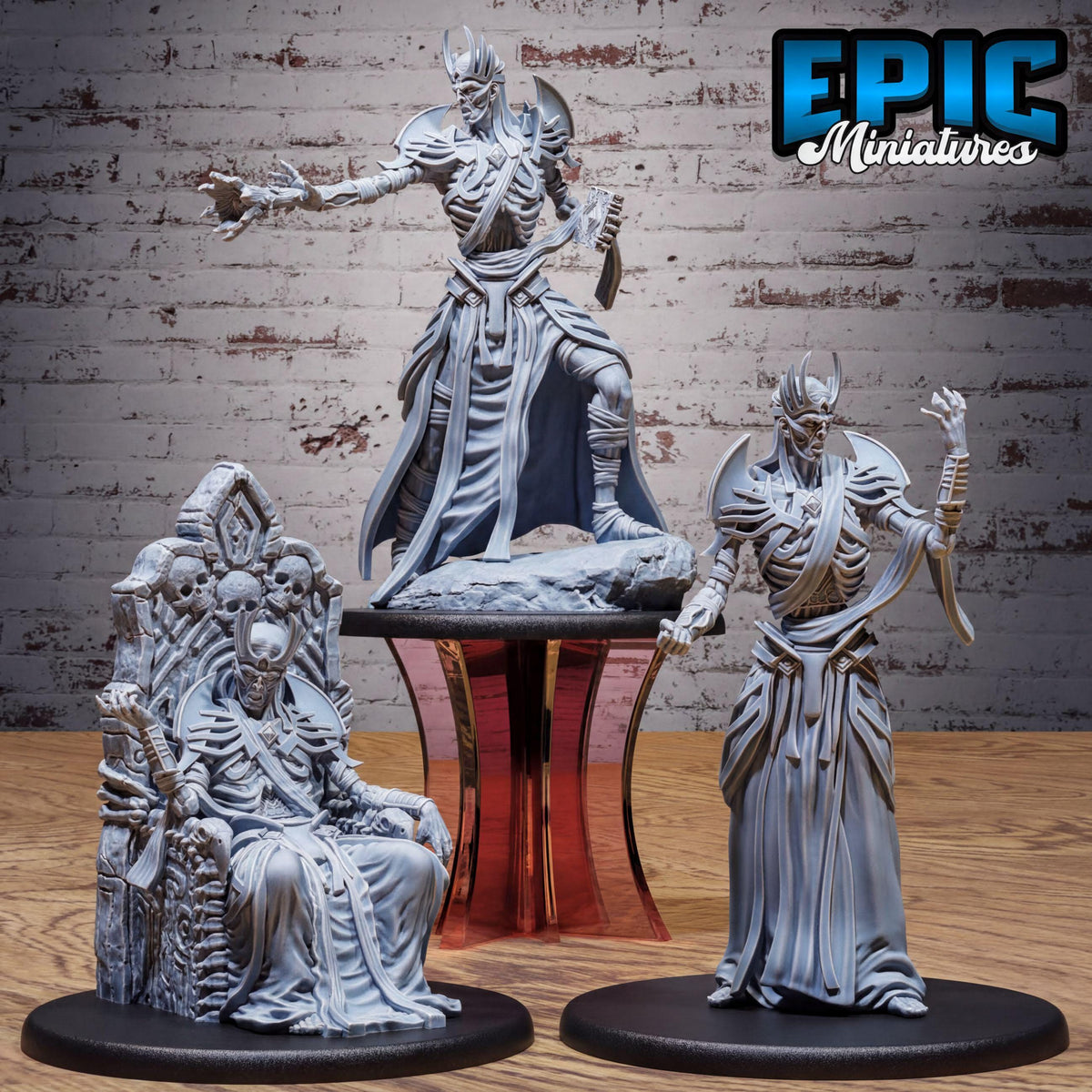 three miniature figurines of characters, including a seated figure, a standing figure, and a kneeling figure, all posed in a dynamic manner.