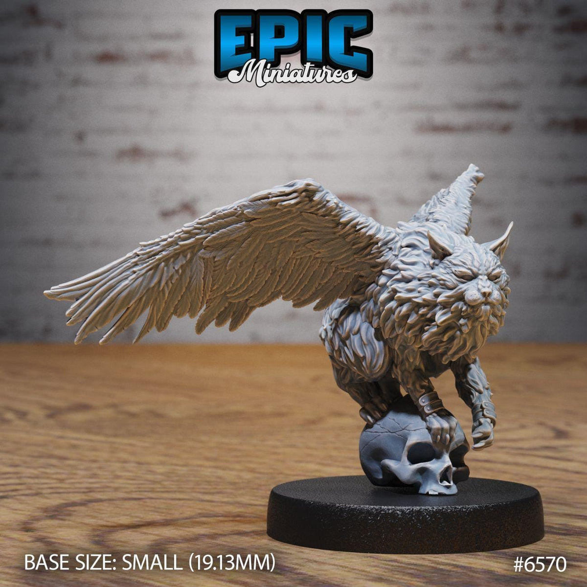 A small figurine of a winged creature, possibly a mythical or fantastical creature, sitting on a skull. The figurine is placed on a black base, and the background is a brick wall.