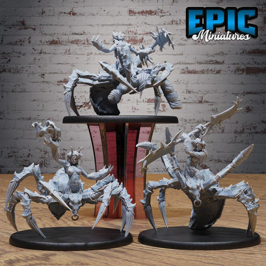 three detailed figurines of fantastical creatures, including large spider-like creatures with sharp claws and intricate designs, displayed on a wooden surface against a brick wall background.