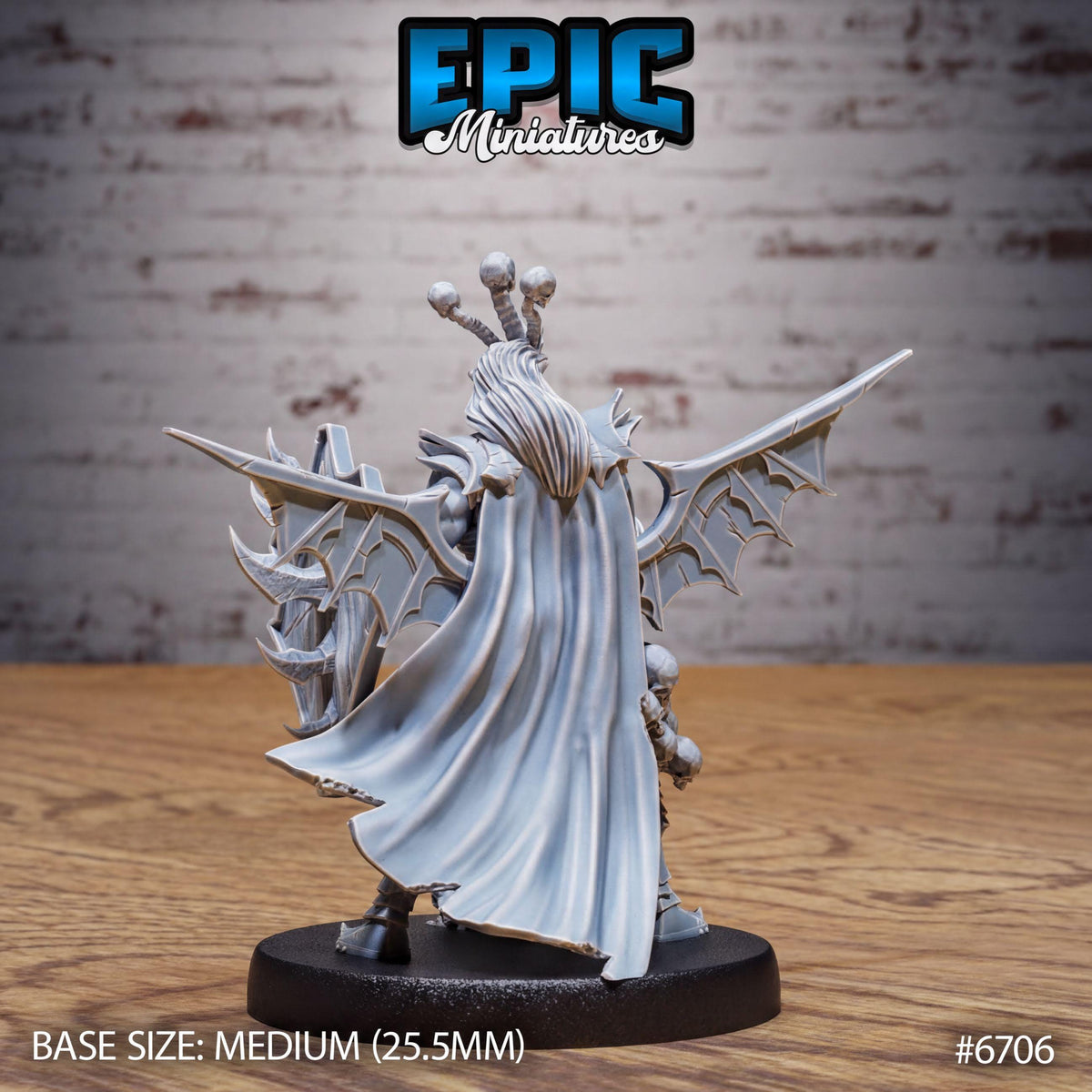 a detailed miniature model of a winged figure with a cape, displayed on a black base. The figure appears to be a fantasy character, possibly a deity or a warrior. The background is a brick wall, which adds to the overall aesthetic of the scene. The image is described as a "BASE SIZE: MEDIUM (25.5mm)" and is numbered "670".