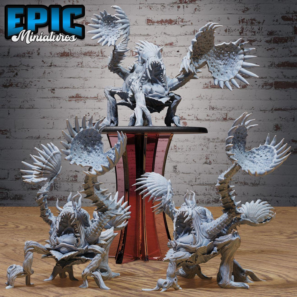 a collection of detailed, intricate figurines of fantastical creatures, including a large, imposing creature with sharp teeth and claws, as well as smaller, more delicate figures. The figurines are arranged on a wooden surface, with a brick wall in the background. The image does not contain any text or additional objects, and the focus is solely on the intricate details and craftsmanship of the figurines.
