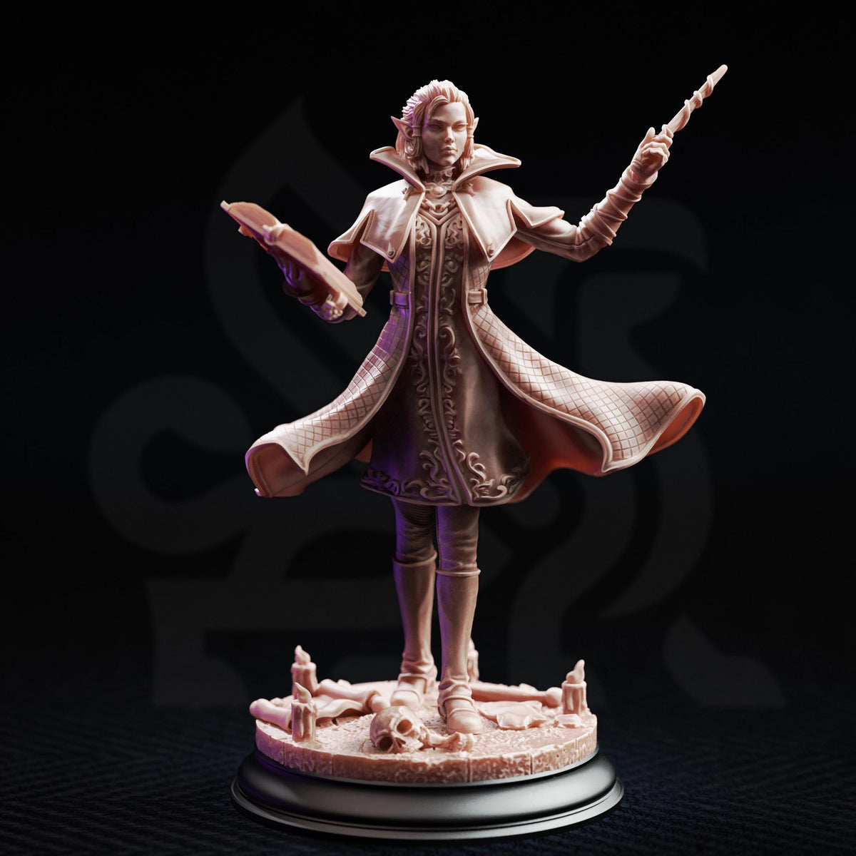 A figurine of a woman with a flowing robe and holding a staff, standing on a base with candles and a skull.