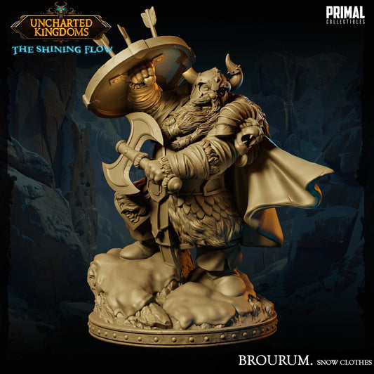 A detailed 3D model of a fantasy character, likely a dwarf or gnome, wearing a fur-trimmed outfit and holding a shield. The character is standing on a rocky base and appears to be in a fighting stance, with a cape billowing behind them. The background is dark and features a rocky landscape, suggesting a mountainous or forested setting. The image is labeled "BROURUM. Snow Clothes" and is described as a "PRIMAL COLLECTION" of fantasy characters.